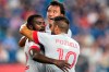 Toronto FC defender Kemar Lawrence, left, is congratulated by midfielder Alejandro Pozuelo (10) after his goal in the first half of an MLS soccer match against the New England Revolution, Wednesday, July 7, 2021, in Foxborough, Mass. At rear is Toronto FC forward Tsubasa Endoh. (AP Photo/Charles Krupa)