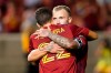 Real Salt Lake's Albert Rusnak, rear, is hugged by Aaron Herrera (22) after scoring on a penalty kick against the Vancouver Whitecaps during the second half of an MLS soccer match Wednesday, July 7, 2021, in Sandy, Utah. (AP Photo/Rick Bowmer)