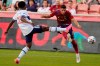 Real Salt Lake midfielder Damir Kreilach, right, shoots as Vancouver Whitecaps' Javain Brown (23) defends during the first half of an MLS soccer match Wednesday, July 7, 2021, in Sandy, Utah. (AP Photo/Rick Bowmer)