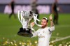 FILE - In this July 16, 2020 file photo, Real Madrid's captain Sergio Ramos lifts the trophy as he celebrates after winning the Spanish La Liga 2019-2020 following a soccer match between Real Madrid and Villareal at the Alfredo di Stefano stadium in Madrid, Spain. Obsessed with winning the Champions League, Paris Saint-Germain added precious experience to its squad by recruiting former Real Madrid captain Sergio Ramos on Thursday. (AP Photo/Bernat Armangue, File)