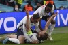 England's Harry Kane, bottom, celebrates with his teammates after scoring his side's second goal during the Euro 2020 soccer semifinal match between England and Denmark at Wembley stadium in London, Wednesday, July 7, 2021. (Laurence Griffiths/Pool Photo via AP)