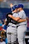 Los Angeles Dodgers relief pitcher Garrett Cleavinger, right, and catcher Will Smith congratulate each other after the Dodgers beat the Miami Marlins 6-1 during a baseball game, Thursday, July 8, 2021, in Miami. (AP Photo/Wilfredo Lee)