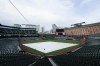 A tarp covers the infield at Oriole Park at Camden Yards after a baseball game between the Baltimore Orioles and the Toronto Blue Jays was postponed for incoming inclement weather as Tropical Storm Elsa approaches Maryland, Thursday, July 8, 2021, in Baltimore. The game will be made up on Sept. 11. (AP Photo/Julio Cortez)