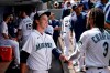 Seattle Mariners starting pitcher Logan Gilbert is congratulated by J.P. Crawford (3) after throwing against the New York Yankees through seven innings of a baseball game Thursday, July 8, 2021, in Seattle. (AP Photo/Elaine Thompson)