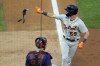 Detroit Tigers' Zack Short tosses some protective gear after he drew a bases-loaded walk off Minnesota Twins' pitcher J.A. Happ during the sixth inning of a baseball game Thursday, July 8, 2021, in Minneapolis. (AP Photo/Jim Mone)