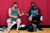 Kevin Love, left, and Kevin Durant laugh while passing a cell phone after practice for USA Basketball, Wednesday, July 7, 2021, in Las Vegas. (AP Photo/John Locher)