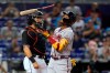 Atlanta Braves' Ronald Acuna Jr., right, flips his bat after striking out, next to Miami Marlins catcher Jorge Alfaro during the first inning of a baseball game Friday, July 9, 2021, in Miami. (AP Photo/Wilfredo Lee)