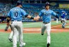 Tampa Bay Rays' Mike Zunino (10) and Brett Phillips celebrate as they score on Austin Meadows' two-run single off Toronto Blue Jays starter Alek Manoah during the third inning of a baseball game Friday, July 9, 2021, in St. Petersburg, Fla.(AP Photo/Steve Nesius)