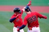 Boston Red Sox's Enrique Hernandez, left, celebrates his solo home run with Alex Verdugo (99) during the first inning of the team's baseball game against the Philadelphia Phillies at Fenway Park, Friday, July 9, 2021, in Boston. (AP Photo/Elise Amendola)