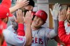 Los Angeles Angels' Shohei Ohtani is greeted in the dugout after he hit a solo home run during the third inning of the team's baseball game against the Seattle Mariners, Friday, July 9, 2021, in Seattle. (AP Photo/Ted S. Warren)