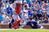 Chicago Cubs'Javier Baez (9) is safe at home plate as St. Louis Cardinals catcher Yadier Molina (4) takes a late throw during the first inning of a baseball game, Friday, July 9, 2021, in Chicago. (AP Photo/David Banks)