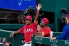 Texas Rangers third base coach Tony Beasley acknowledges cheers from fans during the second inning of the team's baseball game against the Oakland Athletics in Arlington, Texas, Friday, July 9, 2021. Fans cheered after an in-house announcement advising that Beasley would be throwing to Joey Gallo during the All-Star home run derby. (AP Photo/Tony Gutierrez)