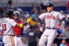 Atlanta Braves' Freddie Freeman, right, is met by Ronald Acuna Jr. (13) after hitting a two-run home run during the fifth inning of a baseball game against the Miami Marlins, Saturday, July 10, 2021, in Miami. (AP Photo/Lynne Sladky)