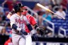 Atlanta Braves' Ozzie Albies tosses his bat after striking out during the first inning of a baseball game against the Miami Marlins, Sunday, July 11, 2021, in Miami. (AP Photo/Lynne Sladky)