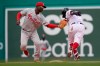 Philadelphia Phillies' Didi Gregorius, left, tags out Boston Red Sox's Christian Vazquez, right, in the sixth inning of a baseball game, Sunday, July 11, 2021, in Boston. (AP Photo/Steven Senne)