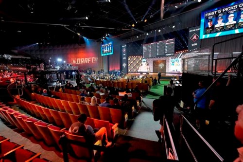 Fans watch during the first round of the 2021 MLB baseball draft, Sunday, July 11, 2021, in Denver. (AP Photo/David Zalubowski)
