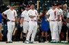 National League's Nolan Arenado, of the St. Louis Cardinals, center, warms-up during batting practice prior to the MLB All-Star baseball game, Tuesday, July 13, 2021, in Denver. (AP Photo/Gabriel Christus)
