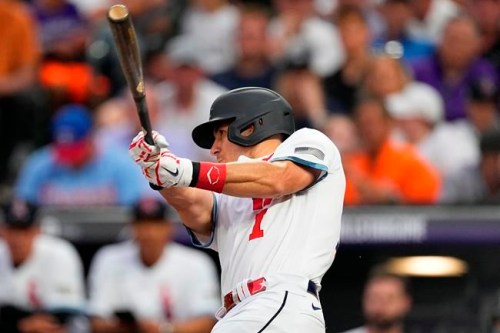 National League's J.T. Realmuto, of the Philadelphia Phillies, follows through on his solo home run during the fifth inning of the MLB All-Star baseball game, Tuesday, July 13, 2021, in Denver. (AP Photo/Jack Dempsey)