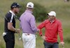 Northern Ireland's Rory McIlroy, right, talks to England's Danny Willett, left England's Lee Westwood during a practice round for the British Open Golf Championship at Royal St George's golf course Sandwich, England, Tuesday, July 13, 2021. The Open starts Thursday, July, 15. (AP Photo/Peter Morrison)