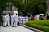 Protesters gather before International Olympic Committee President Thomas Bach visits Hiroshima Memorial Cenotaph Friday, July 16, 2021, in Hiroshima, western Japan. (AP Photo/Eugene Hoshiko, Pool)