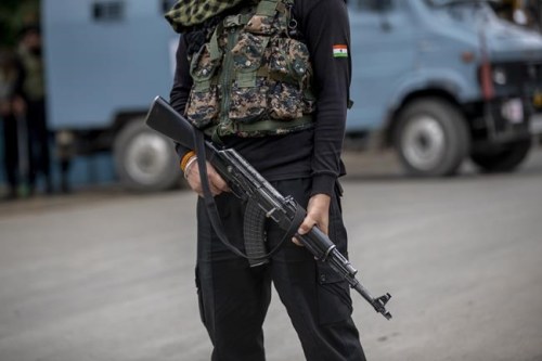 An Indian paramilitary soldier stands guard on a road leading towards the site of a gunfight in Pulwama, south of Srinagar, Indian controlled Kashmir, Wednesday, July 14, 2021. Three suspected rebels were killed in a gunfight in Indian-controlled Kashmir on Wednesday, officials said, as violence in the disputed region increased in recent weeks. Two residential houses were also destroyed. (AP Photo/ Dar Yasin)
