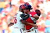 Philadelphia Phillies catcher Andrew Knapp, right, congratulates relief pitcher Ranger Suarez after the team's 5-2 victory in the first baseball game of a doubleheader against the Miami Marlins, Friday, July 16, 2021, in Philadelphia. (AP Photo/Derik Hamilton)