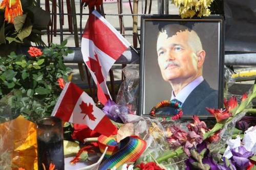 A portrait of the late NDP Leader Jack Layton sits in flowers at a makeshift memorial outside Toronto City Hall on August 26, 2011. THE CANADIAN PRESS/Ryan Remiorz