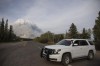 A Prince Albert police car is parked on Highway 55 as a plume of smoke rise from a forest fire burning northeast of the city in Prince Albert, Sask., Monday, May 17, 2021. The Saskatchewan Public Safety Agency has revoked a fire ban as cooler temperatures begin to prevail in the province. THE CANADIAN PRESS/Kayle Neis