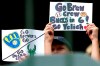 Fans hold signs before a baseball game between the Kansas City Royals and the Milwaukee Brewers, Tuesday, July 20, 2021, in Milwaukee. (AP Photo/Nam Y. Huh)