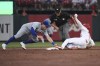 Chicago Cubs second baseman Nico Hoerner, left, attempts to tag out St. Louis Cardinals' Dylan Carlson, who doubled during the third inning of a baseball game Tuesday, July 20, 2021, in St. Louis. (AP Photo/Joe Puetz)