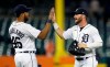 Detroit Tigers' Jeimer Candelario (46) celebrates with Robbie Grossman after the team's 4-1 win over the Texas Rangers in a baseball game Tuesday, July 20, 2021, in Detroit. (AP Photo/Duane Burleson)