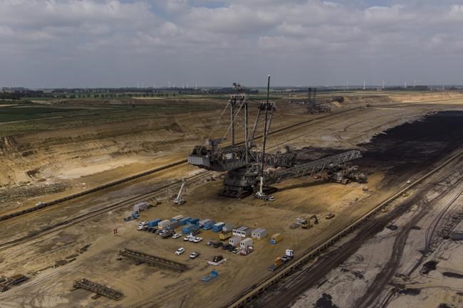 A view of the Garzweiler lignite mine, which attracts many day tourists who visit the mine, in Garzweiler, Germany, Tuesday, July 20, 2021. (AP Photo/Bram Janssen)