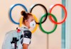 A German athlete wearing a face mask walks past the Olympic rings display on their arrival at Haneda airport in Tokyo on Thursday, July 1, 2021. THE CANADIAN PRESS/Kyodo News via AP