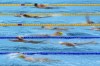 FILE - In this July 21, 2021, file photo, athletes exercise during a swimming training session at the Tokyo Aquatics Centre at the 2020 Summer Olympics in Tokyo, Japan. With hundreds of swimmers scrambling to get their warmup done at the same time, multiple athletes in each lane, everyone diving over one another and some competitors using snorkels, kickboards and other paraphernalia, warmup is organized chaos. (AP Photo/Matthias Schrader, File)