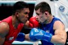 FILE - In this Aug. 31, 2018, file photo, Phillippines' Eumir Felix Marcial, left, and Uzbekistan's Israil Madrimov fight in their men's middleweight boxing semifinal at the 18th Asian Games in Jakarta, Indonesia. Professional boxers will fight at the Olympics this month for the second time following a century of exclusively amateur competition in the sport. More than 40 fighters with pro experience are listed in the Tokyo Olympic field, a sharp increase from just three pros in Rio de Janeiro. (AP Photo/Lee Jin-man, File)