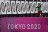 An athlete collects her arrows as she practices for the 2020 Summer Olympics at Yumenoshima Park Archery Field, Sunday, July 18, 2021, in Tokyo. (AP Photo/Charlie Riedel)