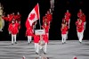 Team Canada flag-bearers Miranda Ayim and Nathan Hirayama carry the Canadian flag at the opening ceremonies during the Tokyo Olympics in Tokyo, Japan on Friday, July 23, 2021. THE CANADIAN PRESS/Adrian Wyld
