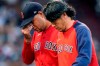 Boston Red Sox starting pitcher Eduardo Rodriguez, left, leaves the baseball game with an injury, accompanied by team trainer Masai Takahashi during the second inning of the team's game against the New York Yankees at Fenway Park, Friday, July 23, 2021, in Boston. (AP Photo/Elise Amendola)