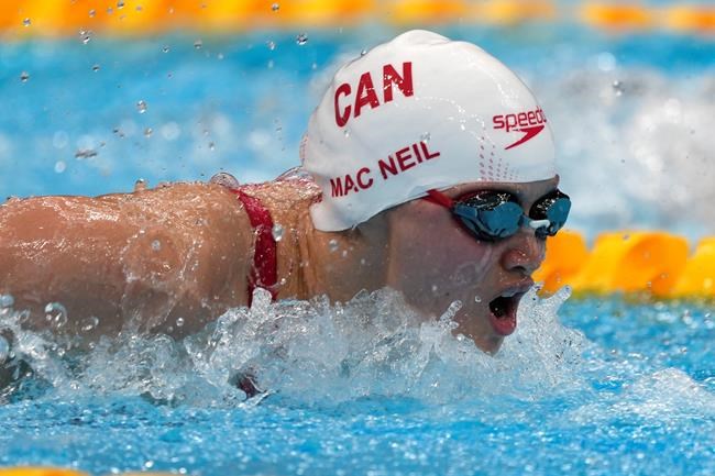 Margaret Mac Neil, of Canada, swims in a heat for the women's 100-meter butterfly at the 2020 Summer Olympics, Saturday, July 24, 2021, in Tokyo, Japan. THE CANADIAN PRESS/AP, Martin Meissner