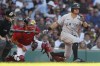 New York Yankees' Brett Gardner, right, strikes out swinging in front of Boston Red Sox's Kevin Plawecki during the sixth inning of a baseball game Saturday, July 24, 2021, in Boston. (AP Photo/Michael Dwyer)