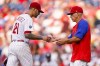 Philadelphia Phillies manager Joe Girardi, right, takes the ball from starting pitcher Vince Velasquez during the third inning of the team's baseball game against the Atlanta Braves, Saturday, July 24, 2021, in Philadelphia. (AP Photo/Chris Szagola)
