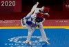 Kimia Alizadeh Zonoozi, Refugee Olympic Team, right, is attacked by Britain's Jade Jones during the taekwondo women's 57kg match at the 2020 Summer Olympics, Sunday, July 25, 2021, in Tokyo, Japan. (AP Photo/Themba Hadebe)