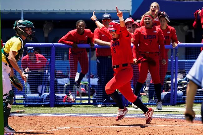 United States' Haylie McCleney scores the game winning run in front of Australia's Belinda White, left, in the eighth inning of a softball game at the 2020 Summer Olympics, Sunday, July 25, 2021, in Yokohama, Japan. (AP Photo/Sue Ogrocki)