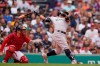 New York Yankees' Rougned Odor, right, hits an RBI single as Boston Red Sox's Christian Vazquez, left, looks on in the third inning of a baseball game, Sunday, July 25, 2021, in Boston. (AP Photo/Steven Senne)