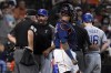 Texas Rangers manager Chris Woodward, second and from left, argues with home plate umpire Tim Timmons (95) after Brock Holt (16) and Woodward were ejected from the game for arguing a called third strike during the fourth inning of a baseball game against the Houston Astros, Sunday, July 25, 2021, in Houston. (AP Photo/Eric Christian Smith)