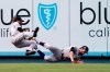 Colorado Rockies right fielder Charlie Blackmon, left, falls after making a catch on a ball hit by Los Angeles Dodgers' Zach McKinstry and colliding with center fielder Sam Hilliard during the sixth inning of a baseball game Sunday, July 25, 2021, in Los Angeles. (AP Photo/Mark J. Terrill)