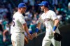 Seattle Mariners' Kyle Seager, left, is greeted by Mitch Haniger, right, after they defeated the Oakland Athletics in a baseball game, Sunday, July 25, 2021, in Seattle. (AP Photo/Ted S. Warren)