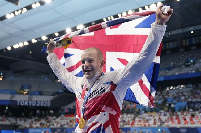 Adam Peaty of Britain celebrates after winning the final of the men's 100-meter breaststroke at the 2020 Summer Olympics, Monday, July 26, 2021, in Tokyo, Japan. (AP Photo/Martin Meissner)