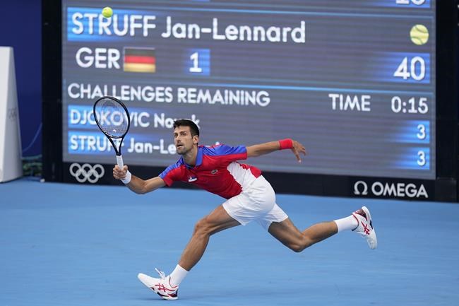Novak Djokovic, of Serbia, returns to Jan-Lennard Struff, of Germany, during second round of the tennis competition at the 2020 Summer Olympics, Monday, July 26, 2021, in Tokyo, Japan. (AP Photo/Patrick Semansky)