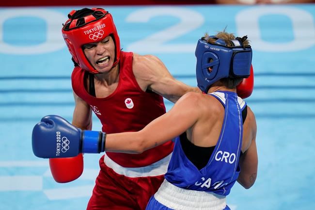 Caroline Veyre, of Canada, left, lands a shot against Croatia's Nikolina Cacic during their feather weight (57kg) preliminary boxing match at the 2020 Summer Olympics, Monday, July 26, 2021, in Tokyo, Japan. THE CANADIAN PRESS/AP/ Frank Franklin II